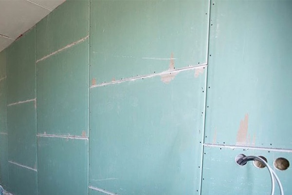 Moisture resistant 12mm MR gypsum board sheets stacked for false ceiling and partition installations